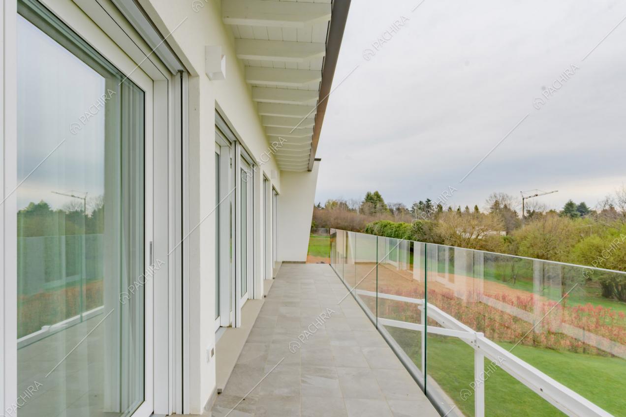 Ringhiera in vetro sulla terrazza con porte-finestre scorrevoli