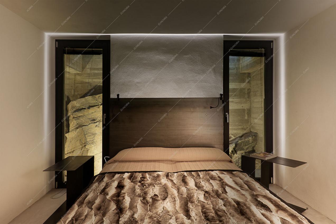 Camera con letto matrimoniale e arredo minimal