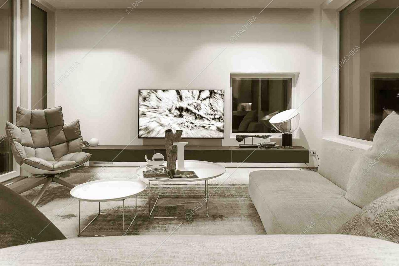 Salotto con poltrona di design, divano angolare e pavimento in parquet