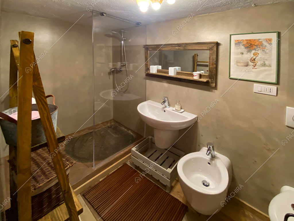 Bagno con pavimento in parquet dello chalet Thar, location in stile rustico ad Aosta