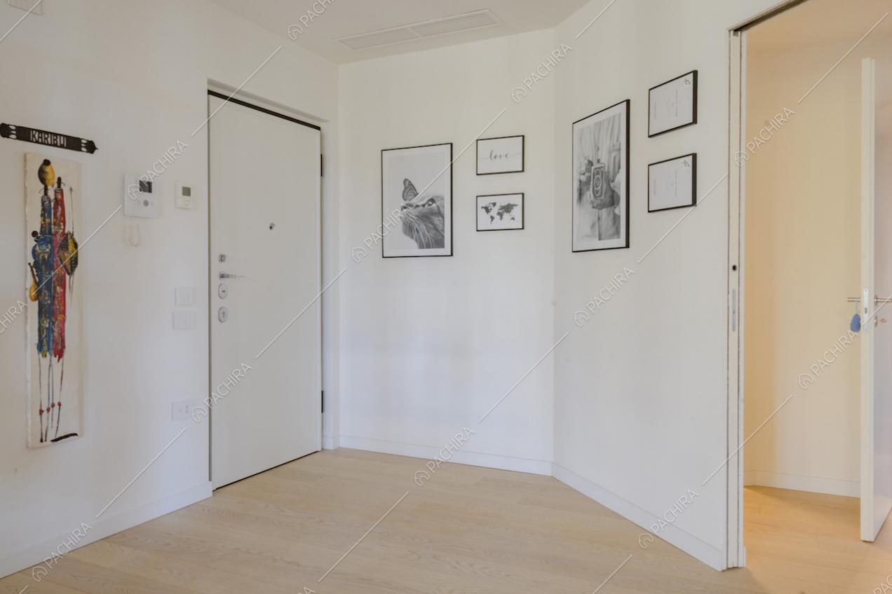 Pareti bianche e foto in bianco e nero appese all'ingresso