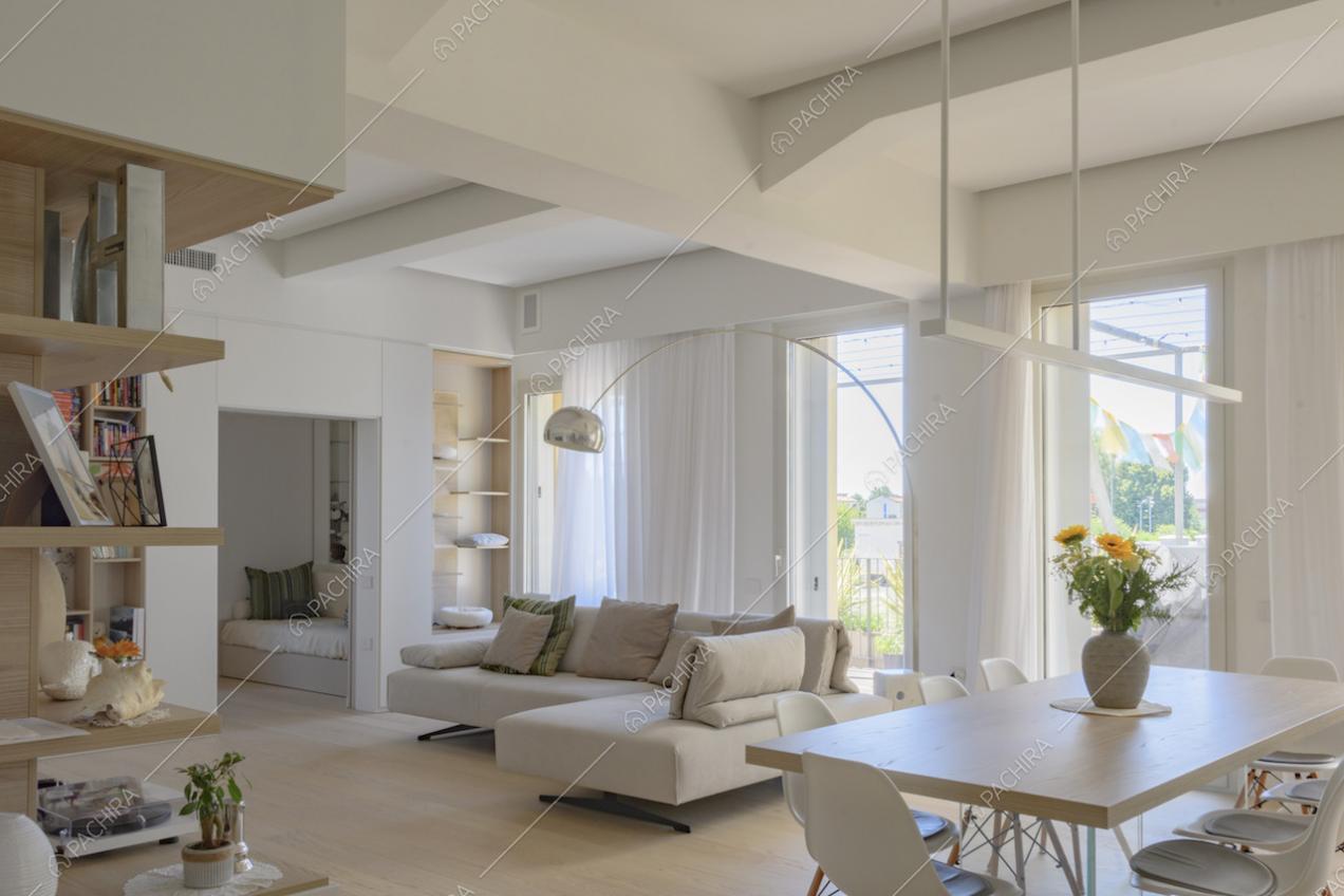 Divano ad angolo grigio chiaro e lampada da terra ad arco